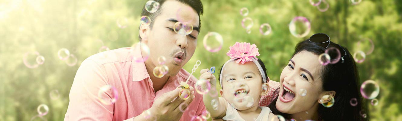 Young family blowing bubbles